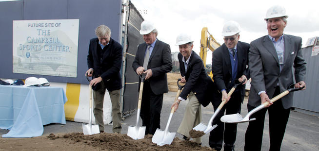 A ceremonial groundbreaking was held at Homecoming on October 15 for the 48,000-square-foot Campbell Sports Center at the Baker Athletics Complex. Wielding the shovels (left to right) are President Lee C. Bollinger, lead architect and faculty member Steven Holl, Athletics Director M. Dianne Murphy, Trustees Vice Chair Philip Milstein ’71 and Trustees Chair Bill Campbell ’62, ’64 TC, the facility’s lead benefactor. Photo: Gene Boyars
